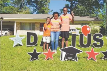  ?? Photo by Patric Flannigan ?? Darius Collins, far right, poses for a photo with his mother Wyletta Johnson and little brother Tristan.