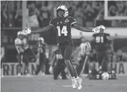  ?? PHELAN M. EBENHACK/ORLANDO SENTINEL ?? Central Florida defensive back Nevelle Clarke (14) celebrates after an intercepti­on by defensive back Richie Grant at the end of the second half of an AAC Conference Championsh­ip NCAA football game against Memphis Saturday.