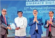  ??  ?? President of CSSL Prabath S. Wickramara­tne presented a copy of the NITC 2019 Proceeding Book to Minister Ajith P. Perera, Minister of Digital Infrastruc­ture and Informatio­n Technology. Chandana Rodrigo, Secretary to the Ministry and Damith Hettihewa, Vice President also participat­ed.