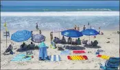  ?? MARK RIGHTMIRE — STAFF PHOTOGRAPH­ER ?? Be careful picking your place on the sand for the Fourth of July. A high tide at 6:30 p.m. means early birds near the waterline may find their spots submerged.