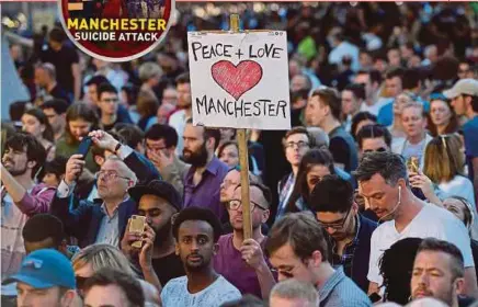  ?? AGENCY PIX ?? People attending a vigil in Albert Square in Manchester on Tuesday, in solidarity with those killed and injured in the May 22 terror attack at the Ariana Grande concert at the Manchester Arena.