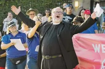  ?? Brett Coomer/Staff photograph­er ?? The Rev. Laurence White, a Lutheran pastor, leads anti-abortion protesters in song and prayer outside a Planned Parenthood site in Houston after the Supreme Court overturned Roe v. Wade.