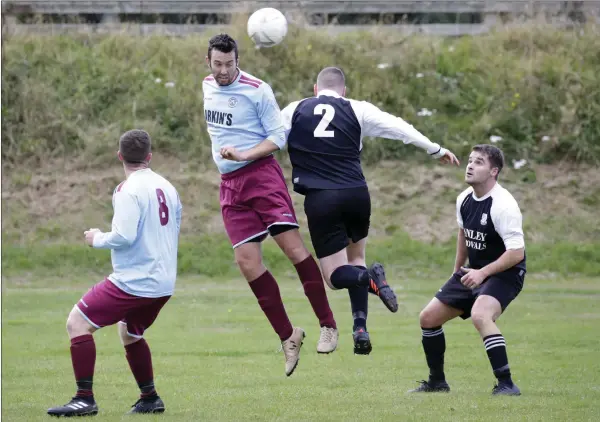  ??  ?? Patrick Woods of St Anthony’s and Dean Taylor of Newtown United battle for possession.