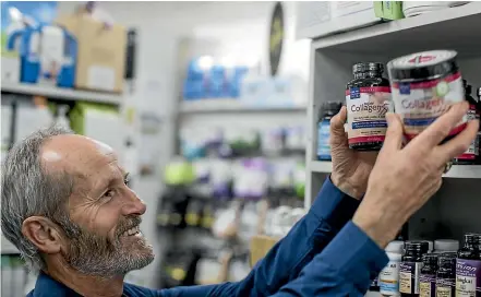  ??  ?? Marshall’s Health &amp; Natural Therapy manager Brent Wilson adds new stock of Neocell Collagen, a supplement that provides a boost of the protein so important for youthfullo­oking skin and healthy joints.