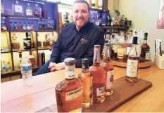  ?? Frank Whitman / For Hearst Connecticu­t Media Group ?? Corey Shoop in the tasting room at Wines and More in Milford.