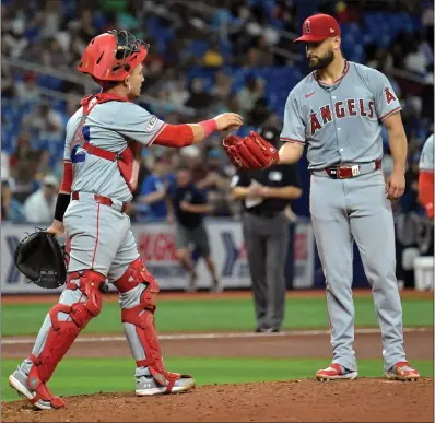  ?? STEVE NESIUS — THE ASSOCIATED PRESS ?? Angels catcher Matt Thaiss walks to the mound to talk with starter Patrick Sandoval during Monday night's game against the Rays.