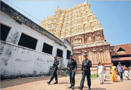  ?? Photo: REUTERS ?? Pepper profits: Police commandos patrol the grounds of Padmanabha­swamy Temple, whose undergroun­d vaults are believed to contain a fortune, some of it acquired through selling pepper, fabrics, rope, rubber and rice to Europeans.