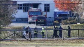  ?? NOAH K. MURRAY ?? Authoritie­s gather Wednesday, Nov. 21, 2018, in Colts Neck,N.J., to investigat­e the aftermath of fatal fire that killed two children and two adults. Authoritie­s say two adults and two children were found dead the day before at the scene of a burning mansion near the New Jersey shore. (AP Photo/Noah K. Murray)