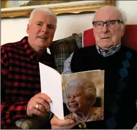  ??  ?? Bill Miller, right, and his son Ken with the birthday card from the Queen