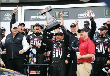  ??  ?? Jimmie Johnson, center, celebrates with car owner Rick Hendrick, left, and crew members after winning the NASCAR Clash auto race at Daytona Internatio­nal Speedway, Sunday, Feb. 10, 2019, in Day-