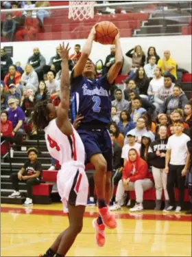  ?? BARRY BOOHER — FOR THE NEWS-HERALD ?? Benedictin­e’s Jashun Cobb drives as Harvey’s Trey Belfour defends on Feb. 18 at Harvey.