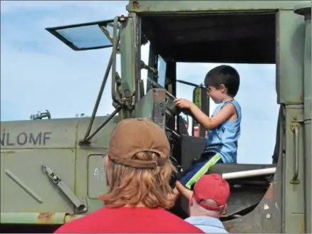  ?? LEAH MCDONALD — ONEIDA DAILY DISPATCH ?? Families explore an assortment of vehicles at this year’s Touch a Truck event at the Glenwood Plaza in Oneida on July 11, 2016. This year’s event will be held Monday, July 10, from 3-8p.m.