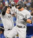  ?? Gavin Napier / Icon Sportswire via Getty ?? Aaron Judge, right, celebrates his home run with Yankees teammate Anthony Rizzo. They’re tied for the MLB lead with nine this season.