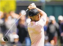  ?? ERIC GAY AP ?? Bryson DeChambeau watches his tee shot at No. 14 in the first round of the PGA Championsh­ip. He’s tied for the lead among golfers who finished the first round.