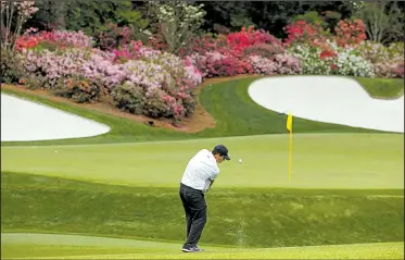  ?? AP/CHARLIE RIEDEL ?? American Patrick Reed hits from short of the 13th green Friday at Augusta National Golf Club. Reed shot a 6-under par 66 to take a two-stroke lead into today’s third round of the Masters.