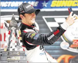  ?? BRIAN LAWDERMILK / GETTY IMAGES ?? Erik Jones takes a selfie with the trophy from the Xfinity race at Texas Motor Speedway. He crashed in Cup practice Friday and will start 36th today.