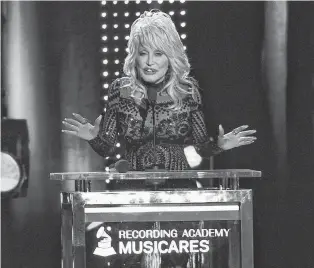  ?? AP PHOTO ?? Dolly Parton accepts her award at Musicares Person of the Year on Friday, at the Los Angeles Convention Center.