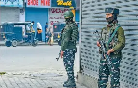  ?? — PTI ?? Security personnel stand guard during a strike in support of JKLF chief Yasin Malik, in Srinagar, on Thursday.