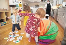  ?? ?? Toddlers Ingrid Breiseth, front, Griffin Covacci, left, and Helena Pompei play under the supervisio­n of Mercedez Gonzales.