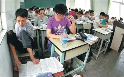  ?? WANG CHUANYUAN AND XU QING / FOR CHINA DAILY ?? Above: Peng Chao, a disabled student from Sichuan province, uses his feet to write notes as he prepares to take the gaokao. a double amputee from Sichuan, is carried from the exam room by her father. Right: Huang Huan,