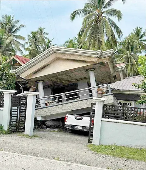  ?? PHOTOGRAPH COURTESY OF IAN BERDIDA ?? FOLLOWING the strong earthquake that rocked Sarangani province on Friday, a semi-concrete house’s terrace collapses on an SUV parked at the residence’s garage.