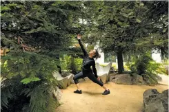  ??  ?? Veronica Bustamante, a resident of the complex at 855 Brannan St., practices yoga in a public redwood infill at Showplace Square.