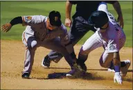  ?? DAVID ZALUBOWSKI — THE ASSOCIATED PRESS ?? Giants second baseman Donovan Solano, left, fields the throw as the Rockies’ Kevin Pillar steals second base on Wednesday.