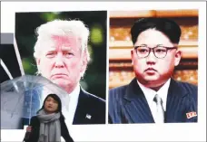  ?? AP PHOTO ?? A woman walks by a huge screen showing U.S. President Donald Trump, left, and North Korea’s leader Kim Jong Un in Tokyo.
