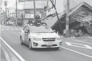  ?? GOOGLE/GETTY Images ?? A Google car mounted with a street view camera drives through a street in the abandoned Japanese town of Namie,
earlier this month.
