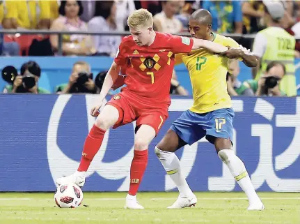  ??  ?? Belgium’s Kevin De Bruyne, (left), is challenged by Brazil’s Fernandinh­o during the quarter-final match against Brazil.