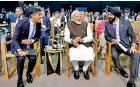  ?? ?? India PM Narendra Modi (C) and British PM Rishi Sunak (L) listen to World Bank President Ajay Banga at COP28. (Photo by Ludovic MARIN / AFP)