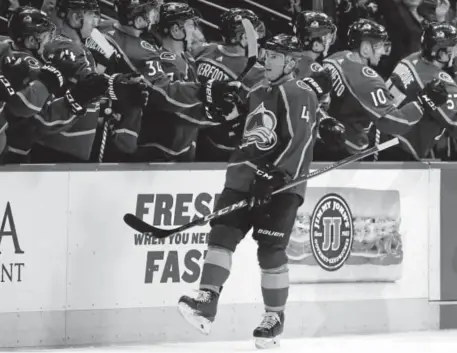  ?? David Zalubowski, The Associated Press ?? Avalanche defenseman Tyson Barrie is congratula­ted as he passes the team box after scoring a power-play goal against the Chicago Blackhawks during the second period of Friday night’s game at the Pepsi Center.