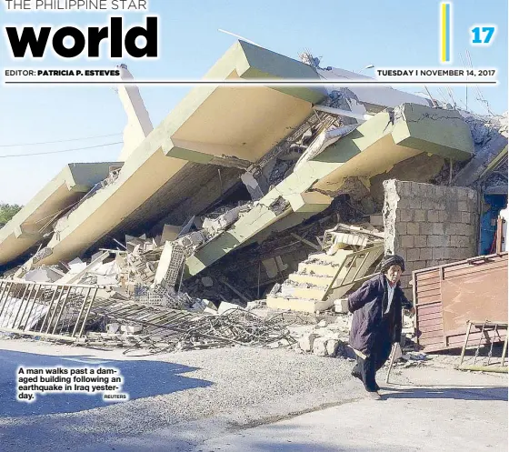  ?? REUTERS ?? A man walks past a damaged building following an earthquake in Iraq yesterday.