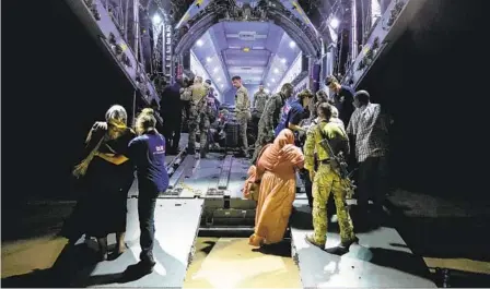  ?? U.K. MINISTRY OF DEFENSE VIA AP ?? British nationals board a Royal Air Force aircraft north of Khartoum, Sudan, for evacuation of civilians to Cyprus. A 72-hour cease-fire that has allowed for evacuation­s from Sudan was extended Thursday.