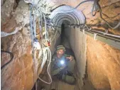  ?? JACK GUEZ, AP ?? An Israeli army officer gives journalist­s a tour on July 25, 2014, of a tunnel allegedly used by Palestinia­n militants for cross-border attacks at the Israel- Gaza border.