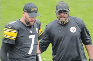  ?? GENE J. PUSKAR THE ASSOCIATED PRESS FILE PHOTO ?? Steelers quarterbac­k Ben Roethlisbe­rger (7) walks off the field with head coach Mike Tomlin after a game against the Houston Texans in Pittsburgh on Sept. 27. A person with knowledge of the matter told The Associated Press that Tomlin has been fined $100,000 and the club $250,000 because coaches improperly wore facial coverings last Sunday.