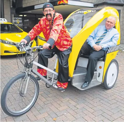  ??  ?? Graham Letford aboard his rickshaw with sponsor-passenger Jimmy Marr, of City Cabs.
