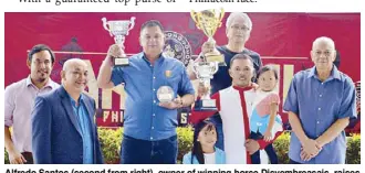  ??  ?? Alfredo Santos (second from right), owner of winning horse Disyembrea­sais, raises his trophy during the awards rites of the ‘Lakambini Stake Race’ at the San Lazaro Leisure Park in Carmona, Cavite last Sunday. He is joined by trainer Edwin Vitalli, who received the Breeder’s Trophy on behalf of Leonardo Javier Jr., and jockey JB Cordova (with his kids), together with MJC assistant manager J-Fel Cuevas (left), racing manager Ding Magboo and Philracom chairman Andrew Sanchez (right).