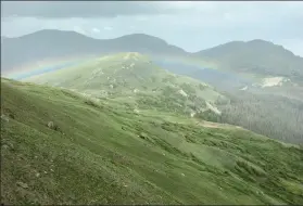  ?? Jackie Hutchins / Loveland Reporter-herald ?? A rainbow can be seen over Old Fall River Road from the Trail Ridge Store atop Trail Ridge Road in Rocky Mountain National Park on Friday.