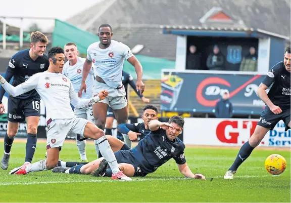  ?? Picture: SNS. ?? Sean Clare scores for Hearts against Dundee during a Premiershi­p clash between the sides at Dens in March 2019.