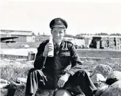  ??  ?? Austen-smith enjoying some refreshmen­t on a captured German airfield at the end of the Second World War