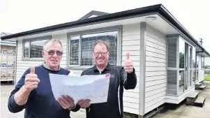  ?? PHOTO: PETER MCINTOSH ?? Record price . . . Otago Polytechni­c carpentry programme manager Graham Dunbar (left) with senior lecturer Kevin Dunbar in front of their 2018 auction house.