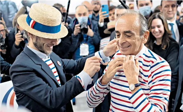  ?? ?? Eric Zemmour tries on a traditiona­l Breton striped shirt at Made In France, an exhibition held to promote France’s top brands – along with products manufactur­ed in the country – at the Porte de Versailles in Paris