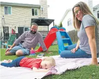  ?? TANNIS TOOHEY ?? Matt and Crystal Roth, with their 14-month-old daughter, Darby, enjoy their new home's backyard in Collingwoo­d, Ont. Although they loved their Leaside rental, a baby changed their priorities.