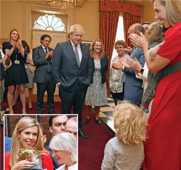  ?? ?? Family first: Mr Johnson smiles down at Wilf, two, inside No 10 amid applause after his speech Left: Nadine Dorries coos over baby Romy in Downing Street as Carrie Johnson looks on proudly
