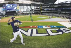  ?? Associated Press photo ?? Milwaukee Brewers' Christian Yelich warms up for practice for Game 1 of the National League Championsh­ip Series baseball game Los Angeles Dodgers Thursday in Milwaukee.