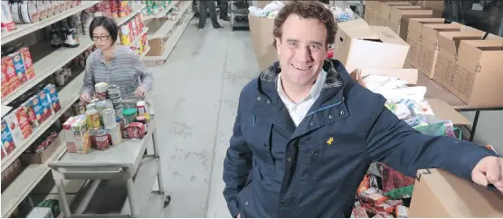  ?? GAVIN YOUNG ?? Dave Howard, president of the Canadian Legacy Project, stands in the Veterans Food Bank which has filled four warehouses with donations in a record food drive.