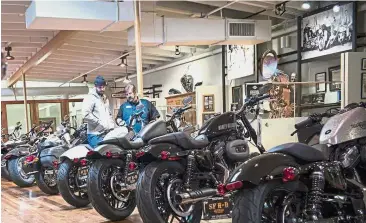  ??  ?? Nice superbikes: Two customers view Harley-Davidson motorcycle­s at the company’s dealership in South San Francisco. The firm it is shifting production of motorcycle­s destined for the EU market out of the US to avoid 31% tariffs. — Bloomberg