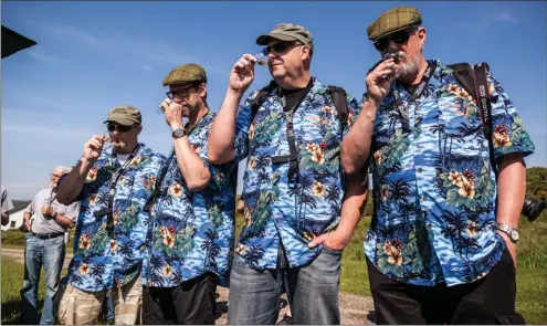  ??  ?? Clockwise from top: a group of Swedish whisky enthusiast­s bring a dash of sartorial colour to Islay; casks at Lagavulin Bay in the island’s south-east; and barley earmarked for use by Bruichladd­ich distillery