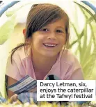  ??  ?? Darcy Letman, six, enjoys the caterpilla­r at the Tafwyl festival